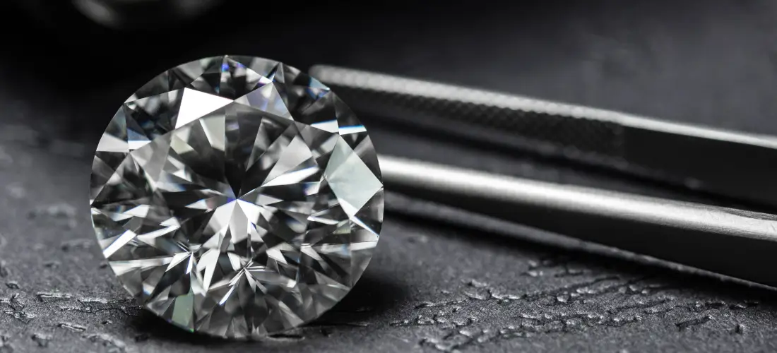 lab grown diamonds versus a diamond on a black surface
