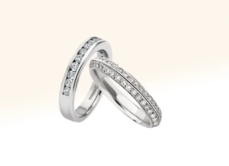 A channel-set diamond eternity ring paired with a two-row milgrain-set eternity ring, showcasing elegant bespoke craftsmanship and timeless design