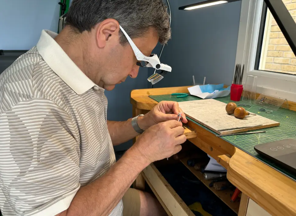 Bespoke wedding ring designer David Law working at the jeweller's bench, crafting a custom piece.