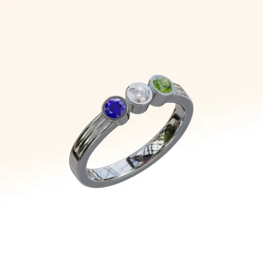 A bespoke birthstone eternity ring set with tanzanite, diamond, and peridot, beautifully crafted to celebrate personal milestones and cherished memories
