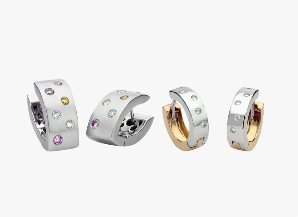 Unique bespoke earrings featuring fancy-colored hoop and diamond accents, crafted in elegant two-tone gold hoop design.