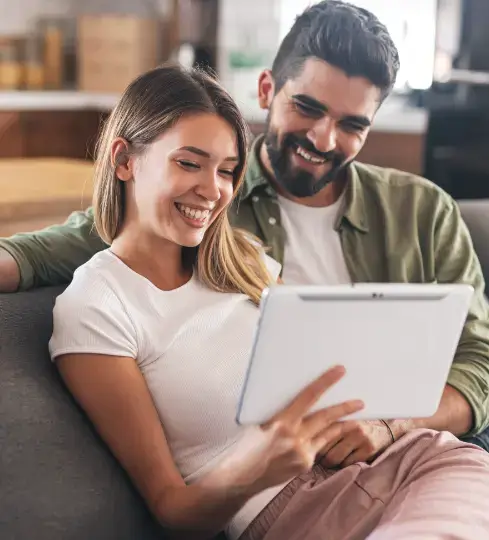 Couple discussing their custom jewellery design with David Law over a video consultation