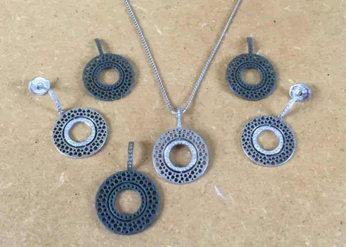 Original wax models alongside the finished diamond earrings and pendant — showing the custom jewellery reimagined process from concept to completion.