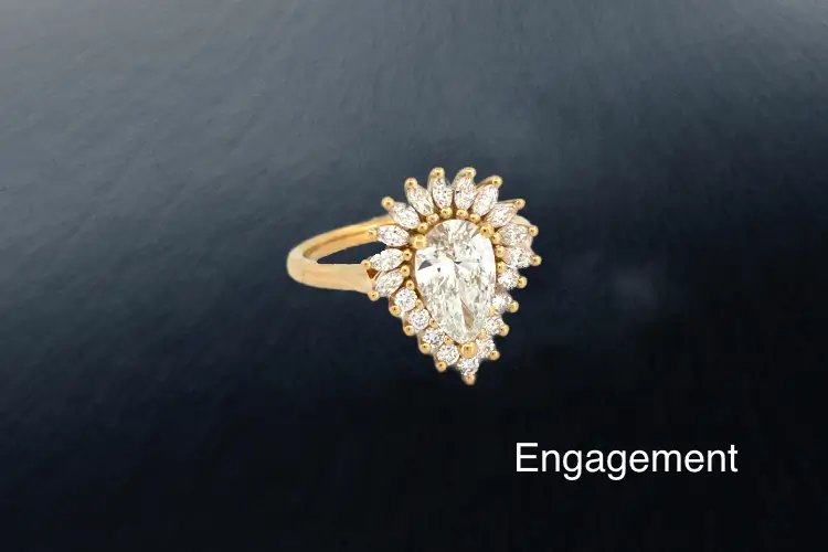 Pear diamond cluster engagement ring designed and handcrafted in London through a bespoke design process with David Law