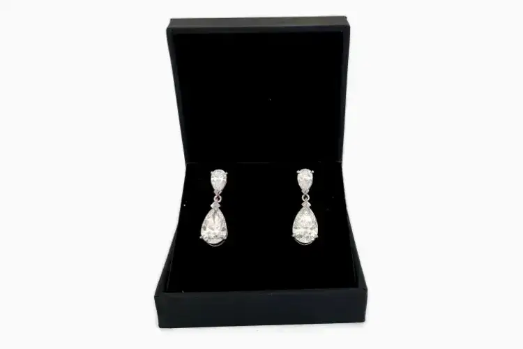 Handmade platinum pear diamond drop earrings designed by London bespoke jeweller David Law