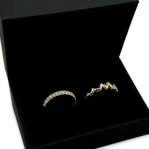 Bespoke wedding rings featuring a ladies’ diamond band and a gents’ band with initials